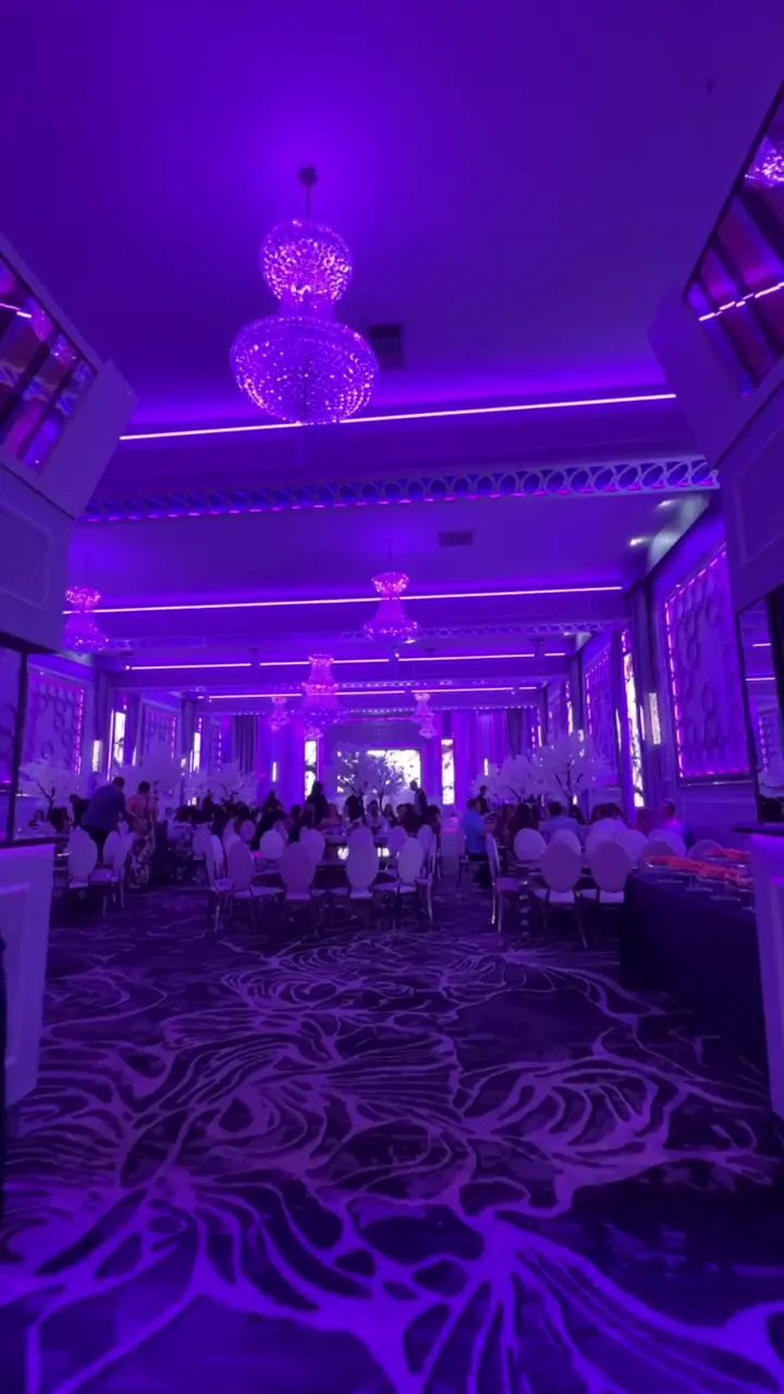 Wedding reception aisle with cherry blossom trees at dining tables