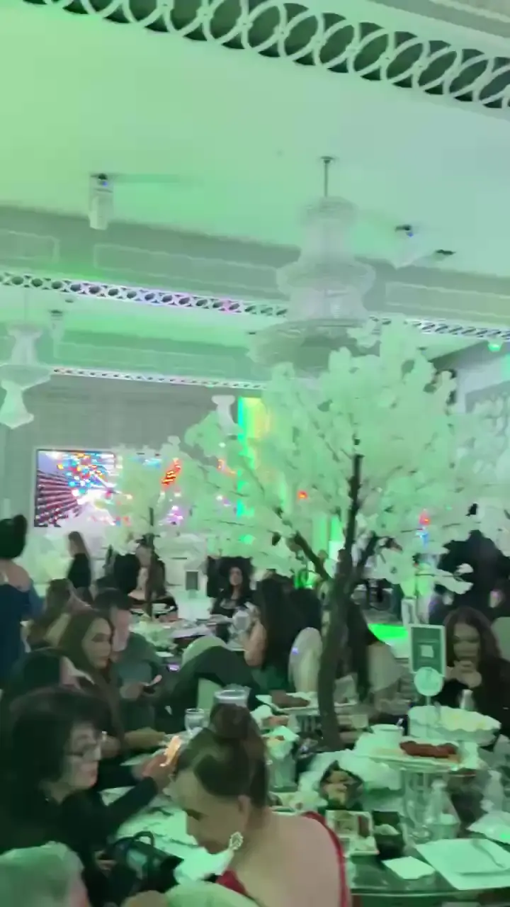 A cherry blossom tree among the wedding dining tables